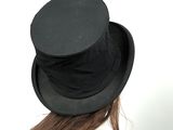 a woman wearing a black top hat and a white shirt