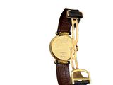 a gold watch with a brown leather band on a white background