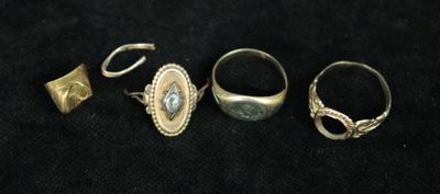 three rings and a ring on a black surface