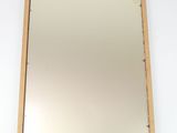 an image of a mirror hanging on a wall in a room
