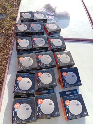 many boxes of cds on a table with a teddy bear