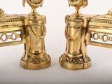 two golden vases sitting on top of each other