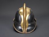 an old helmet with a gold and black design on it