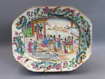 an image of a plate with a picture of a woman and a man in a garden
