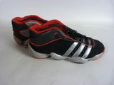 adidas shoes with red and black stripes are on a white surface