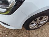 a close up of a car ' s front bumper with a denting on it
