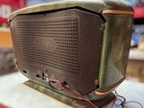 an old radio sitting on top of a table