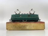 an image of a green train car sitting on top of a wooden platform