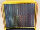 a lot of books that are in a yellow box