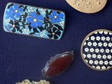 several different types of jewelry are displayed on a blue surface
