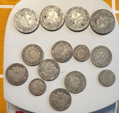 a lot of coins sitting on a scale on a table