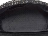 the back of a black purse with a chain hanging from it