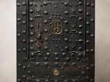 une vieille armoire en métal noir munie d'une porte sur laquelle est gravée la lettre « b »