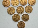 six gold sovereigns are arranged in the shape of a heart
