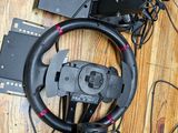a steering wheel and some other electronics on the floor