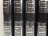 several black cans are stacked on top of each other on a shelf