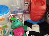 a stuffed frog that is sitting on a table next to other items
