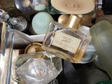 many bottles of perfume sitting on top of each other