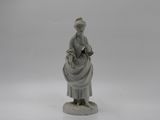 figurine of a woman with a basket on her head