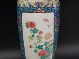 a large vase with flowers on it sitting on a table