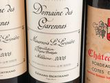 several bottles of wine are lined up on a table