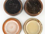 four different types of pottery bowls are shown on a white surface
