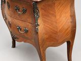 an antique wooden chest of drawers with a marble top