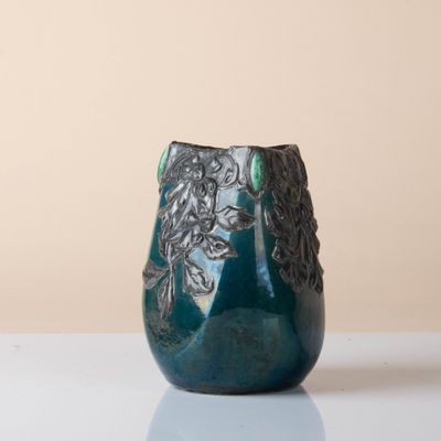 a blue vase that is sitting on a table