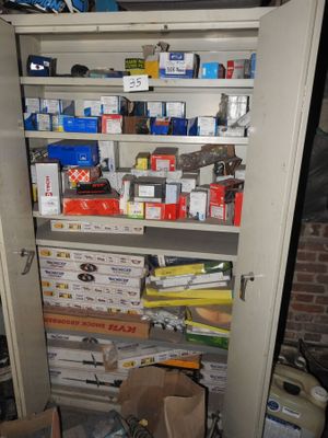 a cupboard full of boxes and other items in a room