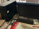 a desk with a computer monitor and a keyboard on it
