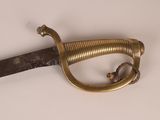 a very old sword that is on display on the table