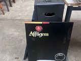 a box of beer sitting on a table next to a grill