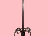 a coat stand with a coat rack on it on a pink background