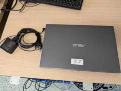 a laptop that is sitting on a desk with a keyboard and mouse