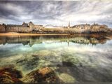 tableau représentant une vue de ville avec un lac au premier plan