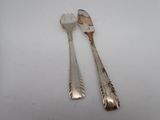 two spoons and a fork on a white surface