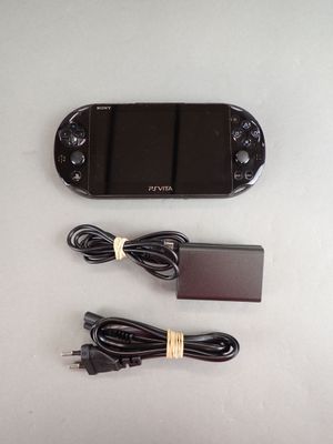a nintendo wii game system and a charger on the table