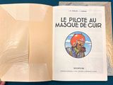 someone is holding a book with a picture of a man in a helmet on it