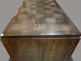 a wooden table with a metal top on a gray surface