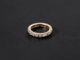 a diamond eternity ring on a black surface
