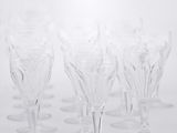 a lot of empty wine glasses on a white table