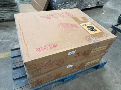 boxes on a pallet in a warehouse with a hand truck in the background