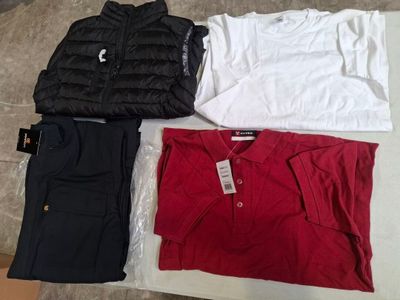 three pairs of men ' s clothing laid out on a bed