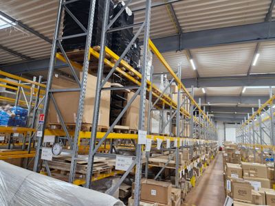 un grand entrepôt rempli de boîtes et de palettes