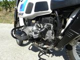 a motorcycle parked on the side of the road with a blue and white stripe on it