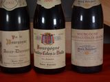 three bottles of wine sitting on a table next to each other