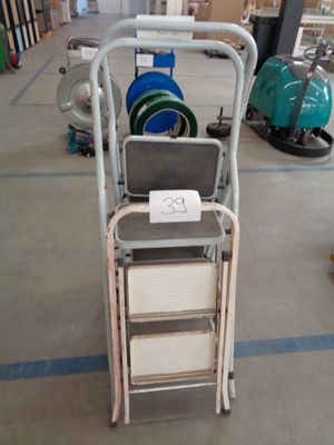 a cart that has a sign on it in a warehouse