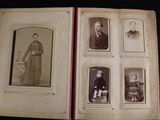 an old photo of a group of people sitting in an open book