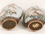 two vases that have been painted with flowers on them