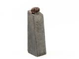 statue of a dog sitting on top of a cement block